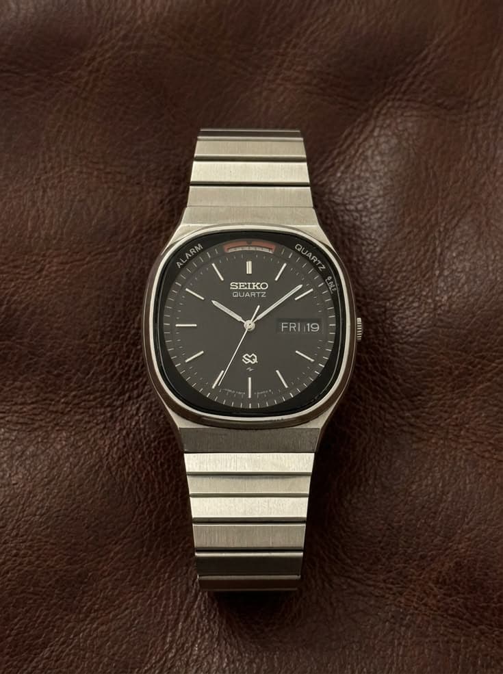 Vintage Seiko Quartz wristwatch with brushed-steel bracelet on rich brown leather